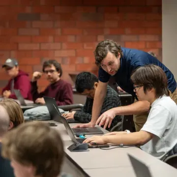 high powered computing classroom, instructor helping a student